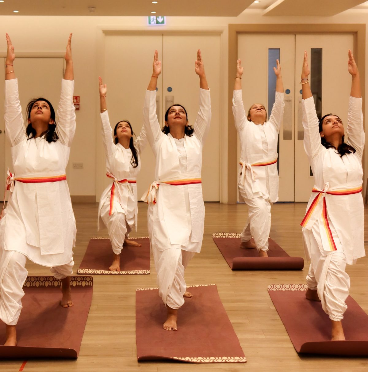 Yoga class in warrior pose at SRMD Bushey